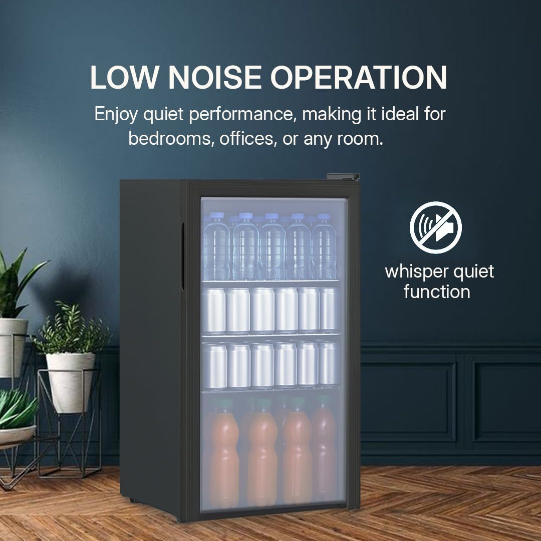 Black refrigerator with glass door displaying bottles, placed indoors with a dark blue wall and wooden floor.